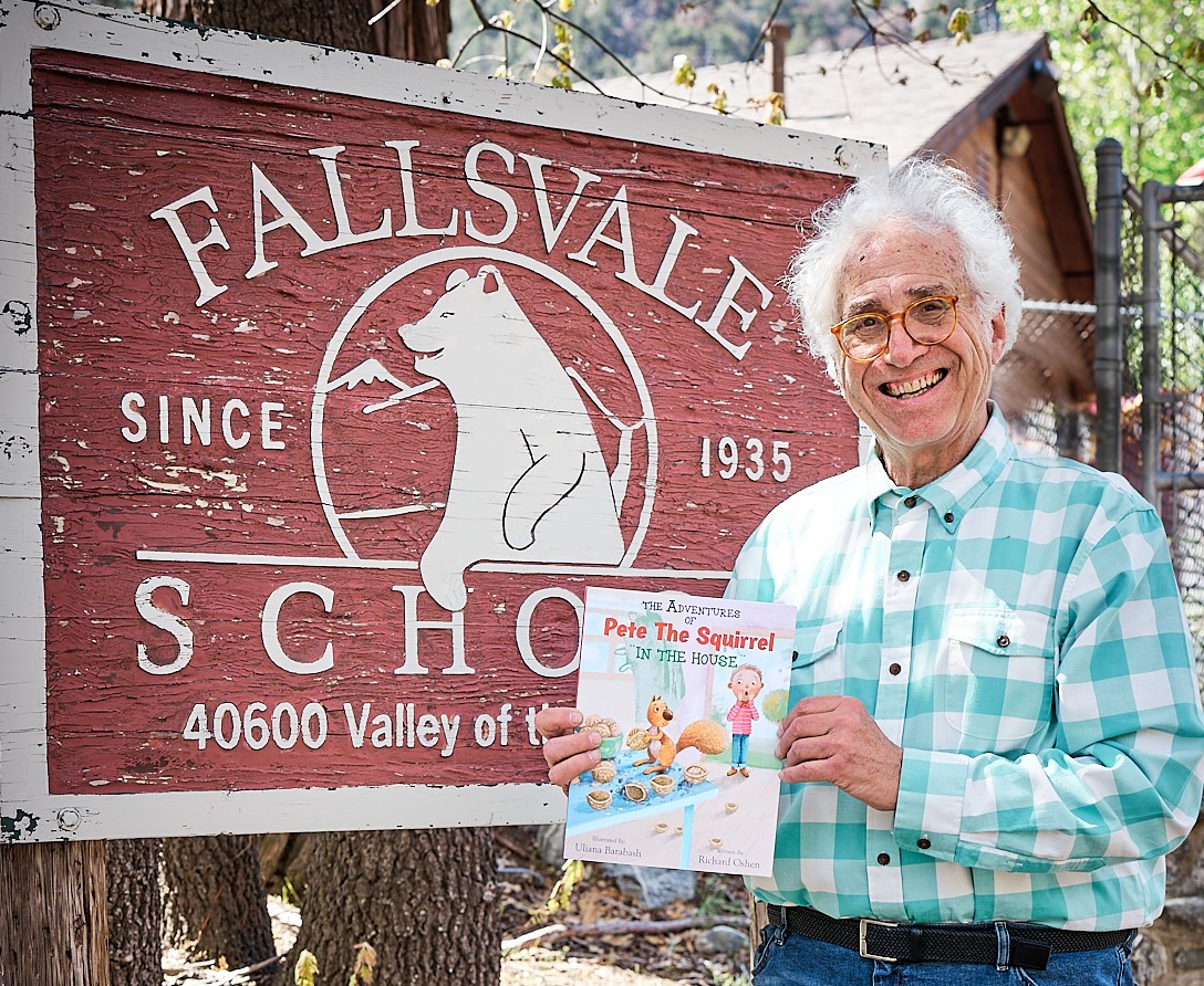 Richard in front of Fallsvalle School sign
